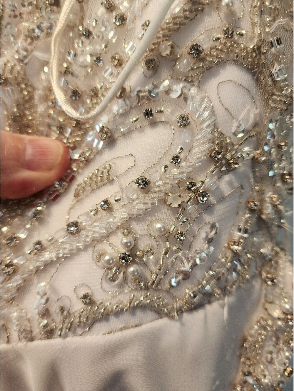 Elegant White Beaded Evening Gown with Sheer Embellished Bodice and Flowing Skit - Picture 5 of 9